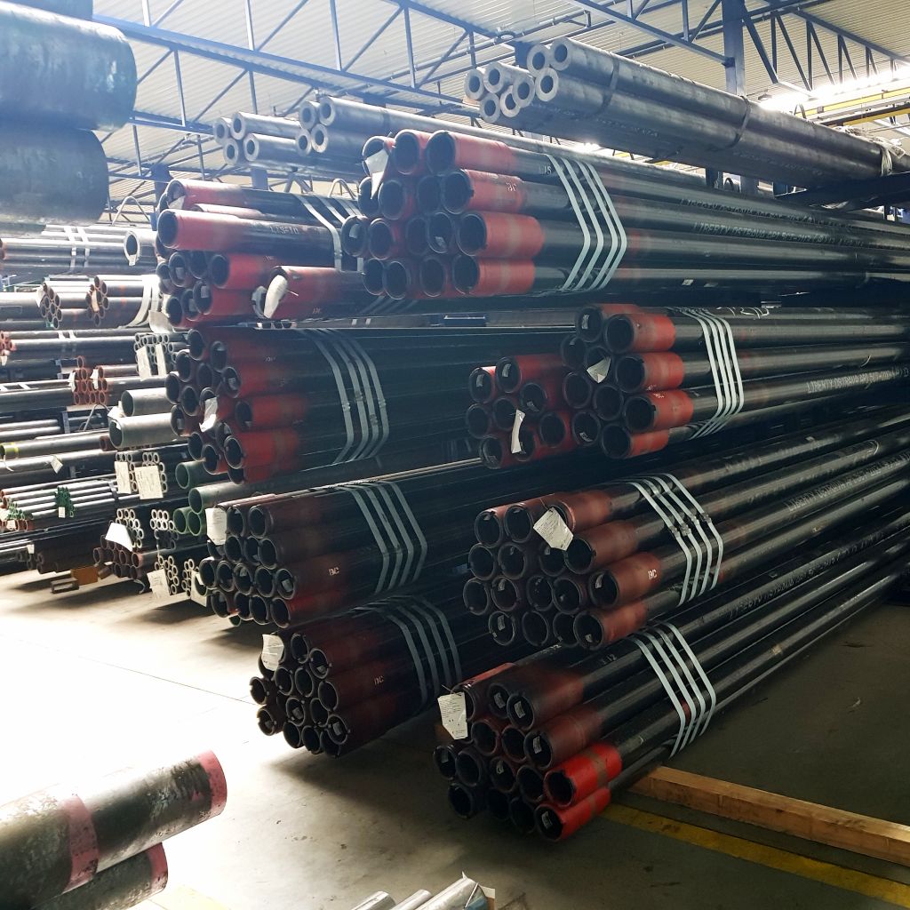 A large collection of pipes stored in a warehouse.